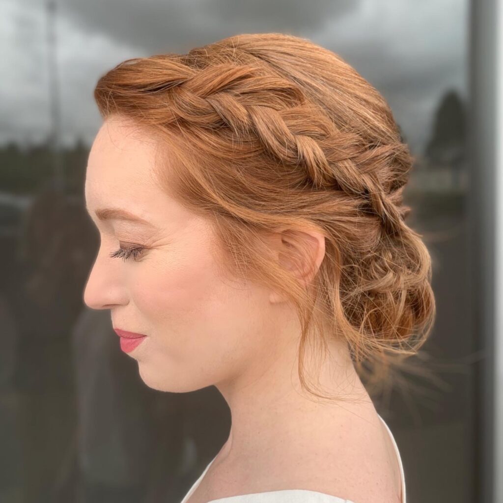 bridal updo with floral hairpin by a stylist at willow hair, eugene OR